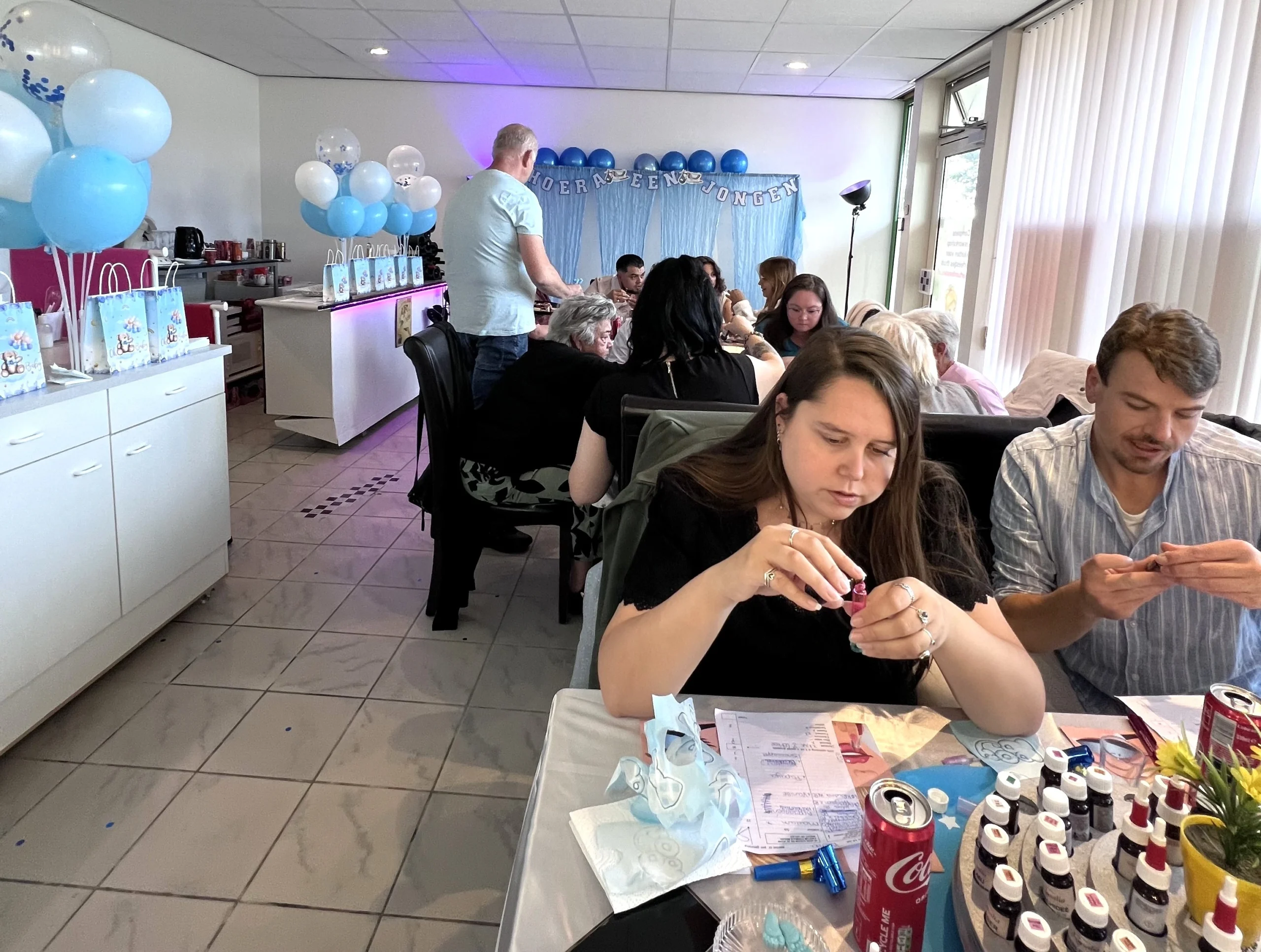 Zelf parfum maken tijdens de babyshower, altijd succes. De deelnemers zijn aandachtig bezig met parfum maken tijdens de babyshower voor een jongetje
